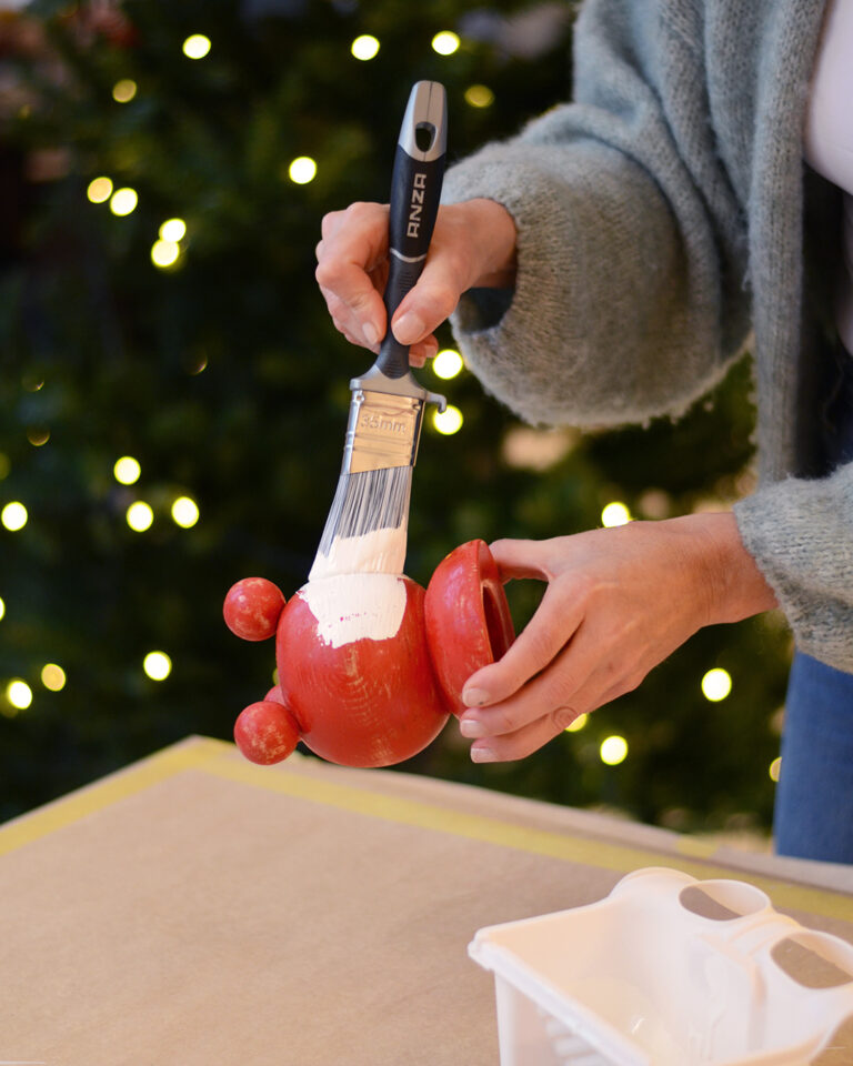 Priming with adhesion primer on old classic wooden candle holders.